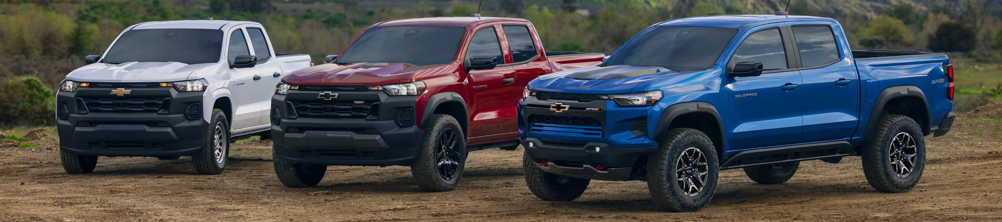 3 2025 Chevrolet Colorado trucks parked next to each other.