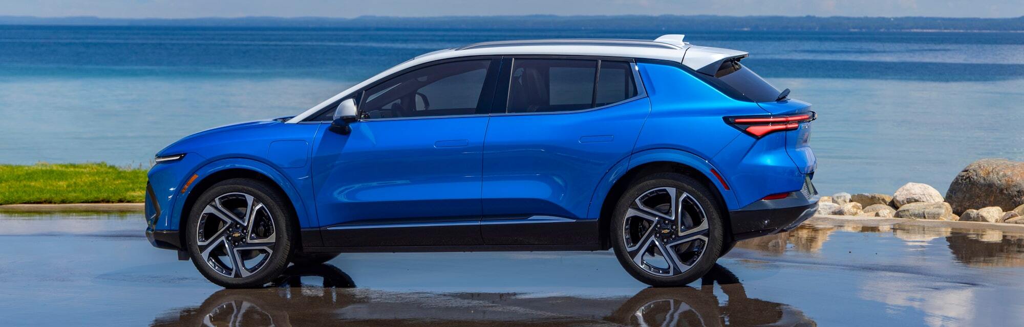 2025 Chevrolet Equinox parked on road during daytime with body of water in background.