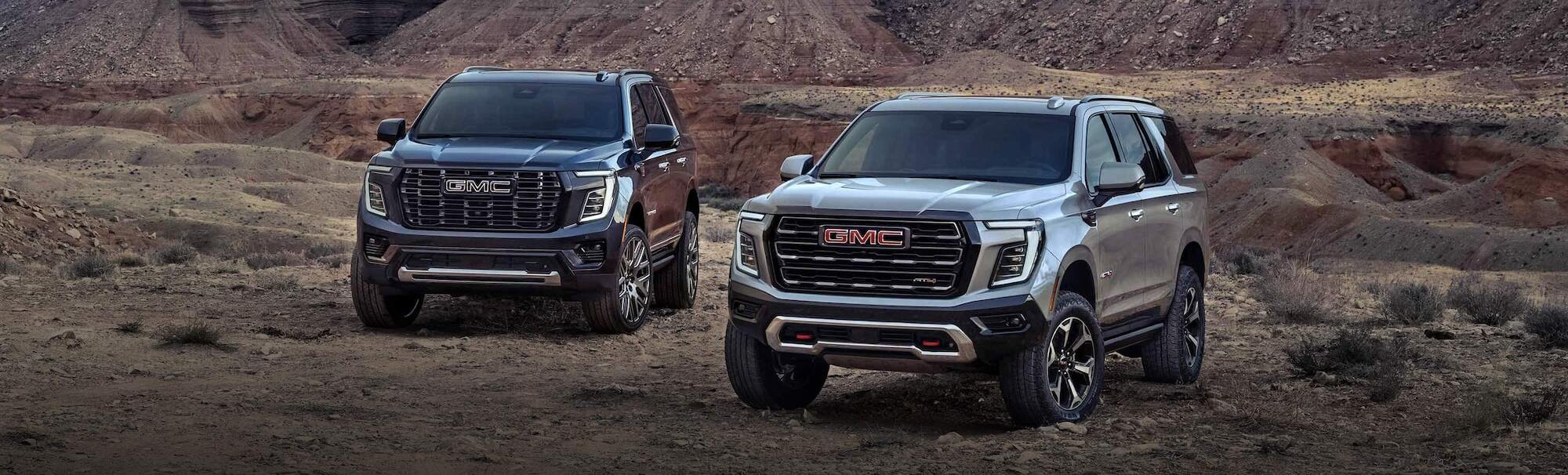2025 GMC Yukon and Yukon XL on dirt road.