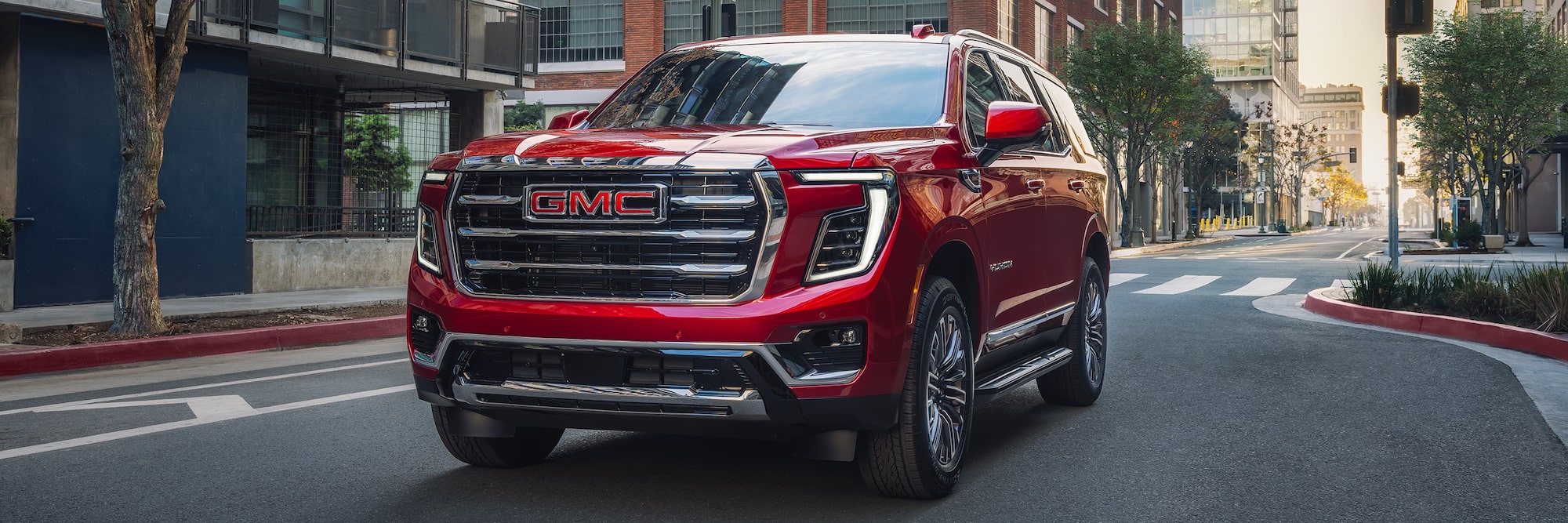 2026 GMC Yukon/Yukon XL driving down city street